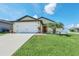 Charming single-Gathering home boasting a well-manicured lawn and a two-car garage for ultimate curb appeal at 1602 Steely Dr, Dundee, FL 33838