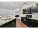 Stylish kitchen featuring granite countertops, stainless steel appliances, and dark wood cabinetry at 1602 Steely Dr, Dundee, FL 33838