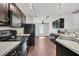 This kitchen boasts dark cabinets, granite countertops, and modern appliances at 1602 Steely Dr, Dundee, FL 33838