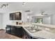 Open-concept kitchen featuring granite countertops, stainless steel appliances, and dark wood cabinetry at 1602 Steely Dr, Dundee, FL 33838