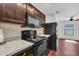 Contemporary kitchen boasting granite countertops, stainless steel appliances, and dark wood cabinetry at 1602 Steely Dr, Dundee, FL 33838