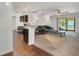 Open-concept living room, with the kitchen in view, that features a sliding glass door to the outside at 1602 Steely Dr, Dundee, FL 33838