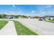 Wide view of the street showing the neighborhood and residences at 1602 Steely Dr, Dundee, FL 33838