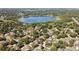 Aerial view of a residential community surrounding a tranquil lake and lush green landscaping at 1784 Sparkling Water Cir, Ocoee, FL 34761