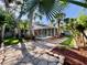 Expansive backyard with a stone path, framed by palm trees and verdant landscaping, leading to pool at 1784 Sparkling Water Cir, Ocoee, FL 34761
