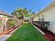 Neatly manicured backyard with a lush lawn, framed by garden beds and mature trees, offering privacy at 1784 Sparkling Water Cir, Ocoee, FL 34761