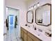Bathroom with double vanity, tile floor, and decorative mirrors at 1784 Sparkling Water Cir, Ocoee, FL 34761