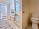 Bright bathroom with a large soaking tub, separate glass shower, and tiled floor at 1784 Sparkling Water Cir, Ocoee, FL 34761