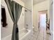 Traditional tub/shower with white tile and a gray shower curtain at 1784 Sparkling Water Cir, Ocoee, FL 34761