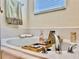 Close-up of a relaxing bathtub with a caddy, faucet, and a towel rack above it at 1784 Sparkling Water Cir, Ocoee, FL 34761