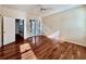 Bright bedroom featuring hardwood floors, ceiling fan, and doors leading to a screened patio at 1784 Sparkling Water Cir, Ocoee, FL 34761