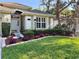 Close-up of front yard with lush green grass, flowering shrubs, and well maintained garden beds at 1784 Sparkling Water Cir, Ocoee, FL 34761