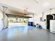 Spacious garage with an open door, painted floors, and ample room for parking and storage at 1784 Sparkling Water Cir, Ocoee, FL 34761