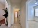 Hallway with neutral paint, tile flooring, and an open view into another bedroom at 1784 Sparkling Water Cir, Ocoee, FL 34761