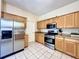 Modern kitchen featuring stainless steel appliances and granite countertops at 1784 Sparkling Water Cir, Ocoee, FL 34761