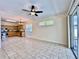 Open-concept kitchen, great room with tiled floors, stainless steel appliances, and natural light at 1784 Sparkling Water Cir, Ocoee, FL 34761