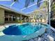 A refreshing in-ground pool enclosed in a screen, surrounded by lush landscaping and a serene atmosphere at 1784 Sparkling Water Cir, Ocoee, FL 34761