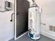 Water heater situated near a doorway, featuring updated plumbing and electrical components for modern efficiency at 1784 Sparkling Water Cir, Ocoee, FL 34761