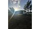 View of the backyard with a screened in back porch at 1821 N Reedy Lake Blvd, Frostproof, FL 33843