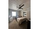 This bedroom features a ceiling fan and a built-in wall shelf for storage at 1821 N Reedy Lake Blvd, Frostproof, FL 33843