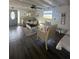 Bright living room with a dark wood-look floor and a gray door at 1821 N Reedy Lake Blvd, Frostproof, FL 33843