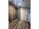 Open shower with wood look tile and glass door and wood accent wall at 1821 N Reedy Lake Blvd, Frostproof, FL 33843