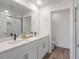 Clean bathroom with dual sinks, a sliding glass shower door and wood-look flooring at 185 E Warren Ave, Longwood, FL 32750