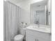 Bathroom with white vanity, modern fixtures, and shower with gray curtain at 185 E Warren Ave, Longwood, FL 32750