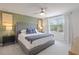 Bedroom featuring a bed with a tufted headboard, bedside tables, and large window at 185 E Warren Ave, Longwood, FL 32750