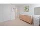 Bedroom featuring a light wood dresser, neutral decor, and carpeted floors at 185 E Warren Ave, Longwood, FL 32750