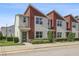 Charming townhouse featuring a modern design, complemented by lush landscaping and a welcoming facade at 185 E Warren Ave, Longwood, FL 32750