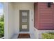 Inviting front door with sidelights, modern hardware, and a personalized welcome mat at 185 E Warren Ave, Longwood, FL 32750
