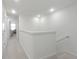 Bright hallway with neutral carpet, recessed lighting, leading to a sunlit office space at 185 E Warren Ave, Longwood, FL 32750