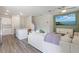 Open concept living area with a modern kitchen, comfortable seating, and a large screen television at 185 E Warren Ave, Longwood, FL 32750