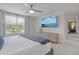 Bright main bedroom with a ceiling fan, large window and a dresser with a TV on top of it at 185 E Warren Ave, Longwood, FL 32750