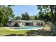 Beautiful backyard with a sparkling pool, barbecue, and landscaped greenery, ideal for outdoor living and entertaining at 2074 Dunsford Dr, Orlando, FL 32808