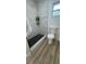 Tiled bathroom with black hex shower tile and updated shower, a clean and modern design at 2074 Dunsford Dr, Orlando, FL 32808