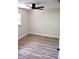 Bright, spacious bedroom featuring modern wood-look floors and a ceiling fan, offering a comfortable living space at 2074 Dunsford Dr, Orlando, FL 32808