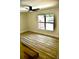 Neutral bedroom featuring wood-look floors, a window and a ceiling fan offering a move in ready space at 2074 Dunsford Dr, Orlando, FL 32808