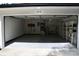 Spacious two-car garage with epoxy floors, shelving, and ample storage space for vehicles and equipment at 2074 Dunsford Dr, Orlando, FL 32808