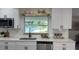 Bright kitchen featuring white cabinets, quartz countertops, and a view of the pool at 2074 Dunsford Dr, Orlando, FL 32808