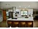 Modern kitchen with white cabinetry, stainless appliances, an island with seating, and wood-style flooring at 2074 Dunsford Dr, Orlando, FL 32808