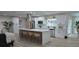 Modern kitchen featuring stainless steel appliances, a large island with bar seating, and ample white cabinetry at 2074 Dunsford Dr, Orlando, FL 32808