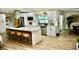 Bright kitchen featuring white cabinets, stainless steel appliances, and an island with seating at 2074 Dunsford Dr, Orlando, FL 32808