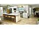 Modern kitchen with a spacious island, stainless steel appliances, and bright lighting at 2074 Dunsford Dr, Orlando, FL 32808