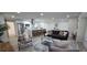 Spacious living room with kitchen view, featuring modern furniture, stylish decor, and abundant natural light at 2074 Dunsford Dr, Orlando, FL 32808