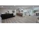 Open floor plan showcasing the kitchen, living room and dining area with wood-look floors and recessed lighting at 2074 Dunsford Dr, Orlando, FL 32808