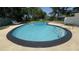 A private pool with steps, surrounded by a concrete deck and green foliage, perfect for relaxation at 2074 Dunsford Dr, Orlando, FL 32808