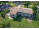 Aerial view of the home with a spacious yard and mature trees at 220 Hillside Dr, Lakeland, FL 33803