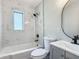 Bright bathroom featuring modern fixtures, white marble tile and a stylish round mirror at 220 Hillside Dr, Lakeland, FL 33803
